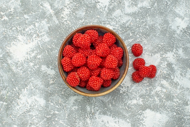 Top view red raspberry confitures inside pot on white background candy confiture sweet sugar tea