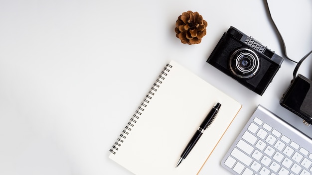 Top view retro photo camera with a notebook