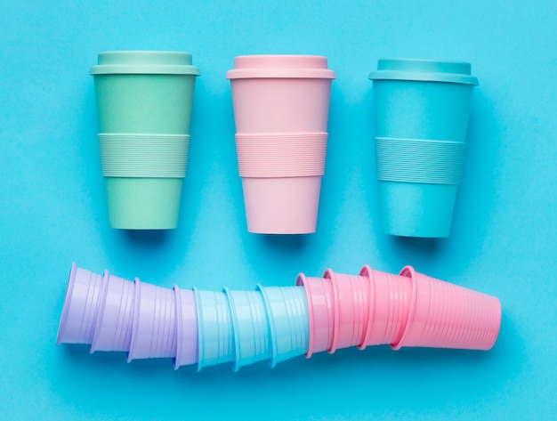 Free photo top view reusable cups with plastic cups