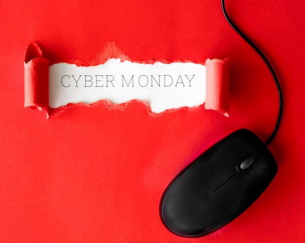 Top view of ripped paper with mouse for cyber monday