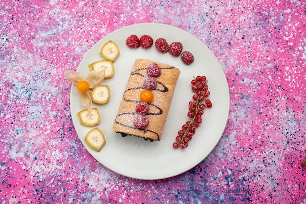 Free Photo top view roll cake with fruits inside white plate on the colored background cake biscuit sweet color