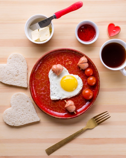 Top view of romantic breakfast and heart-shaped egg with toast