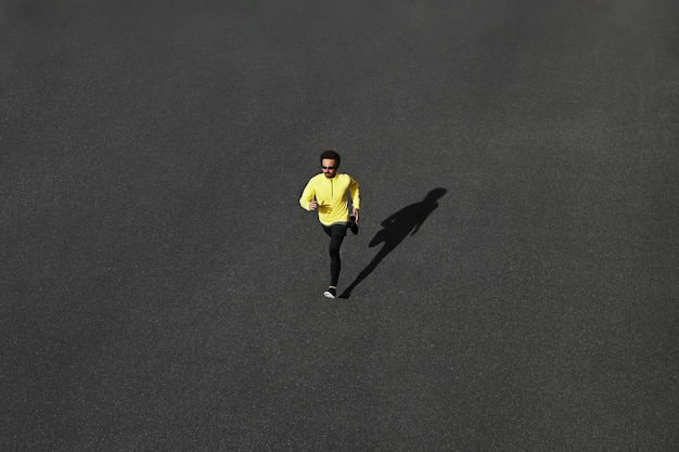 Top view runner man sprinting on road