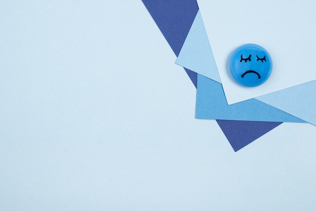 Top view of sad face for blue monday with paper