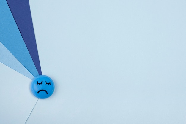 Top view of sad face with paper for blue monday