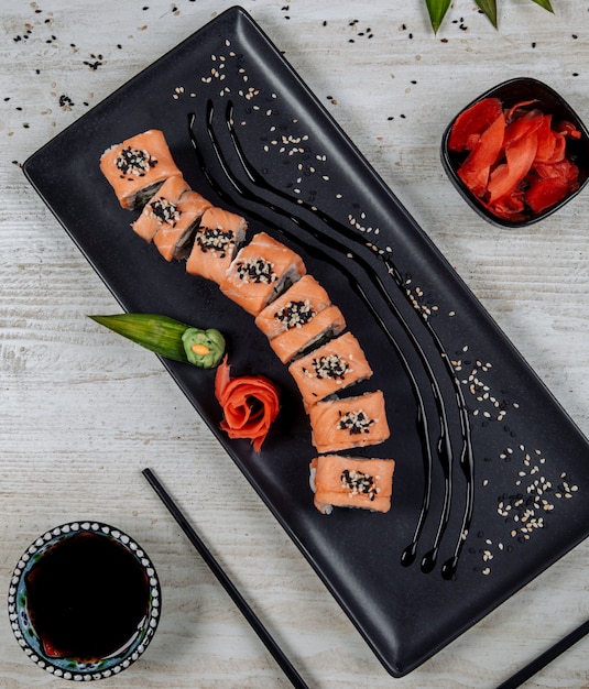 Free Photo top view of salmon sushi roll served with ginger, wasabi and soy sauce