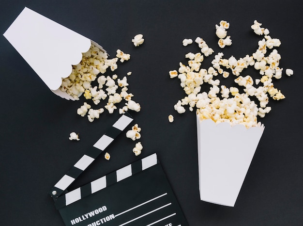 Top view salted popcorn with cinema clapperboard