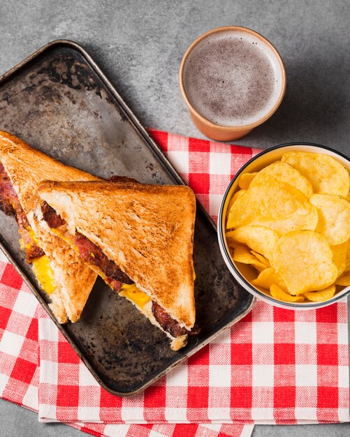 Top view sandwich with bacon and cheese with chips