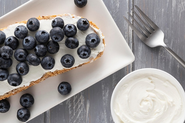 Top view sandwich with cream cheese and blueberries on plate