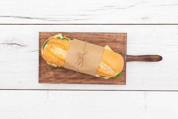 Free photo top view of sandwich wrapped with paper