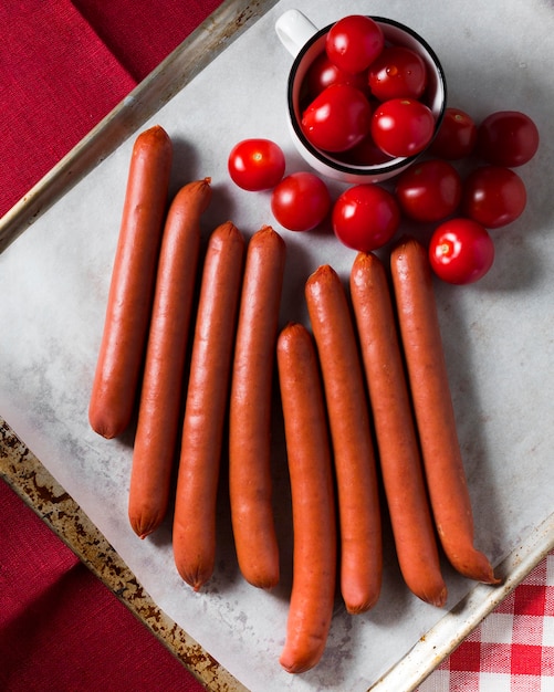 Top view sausages and cherry tomatoes