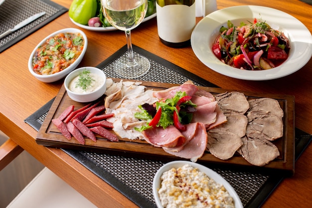 A top view sausages on desk with white wine and vegetables on the table food meal restaurant meat