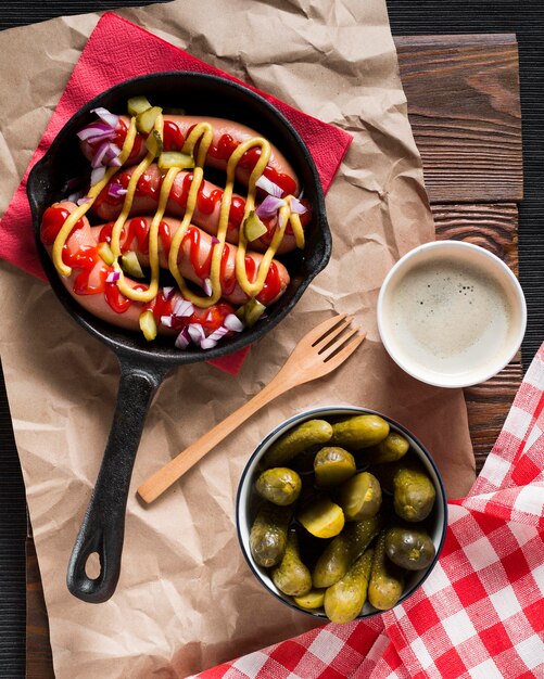 Top view sausages in pan with sauces