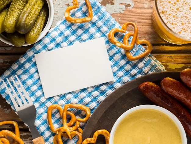 Top view of sausages with pretzels and beer