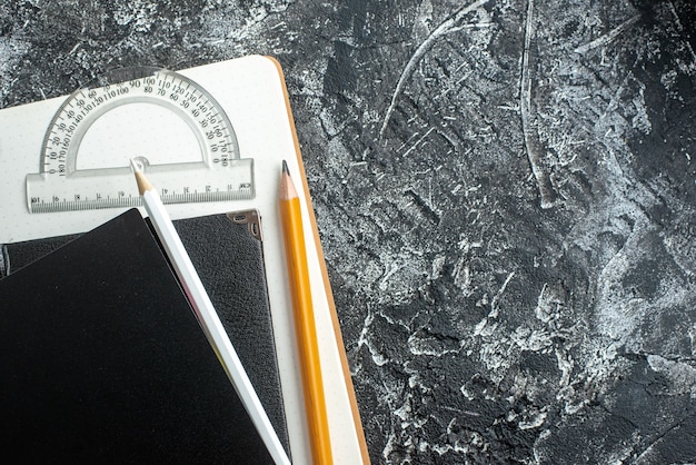 Free photo top view of school supplies on dark surface