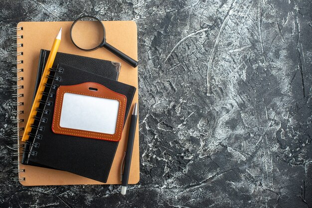 Top view of school supplies on dark surface