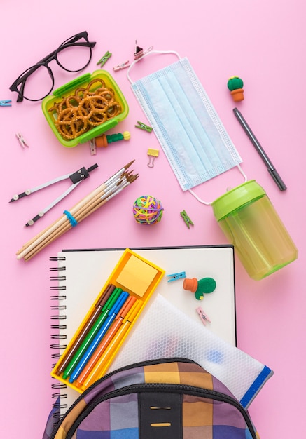 Free Photo top view of school supplies with book bag and pencils