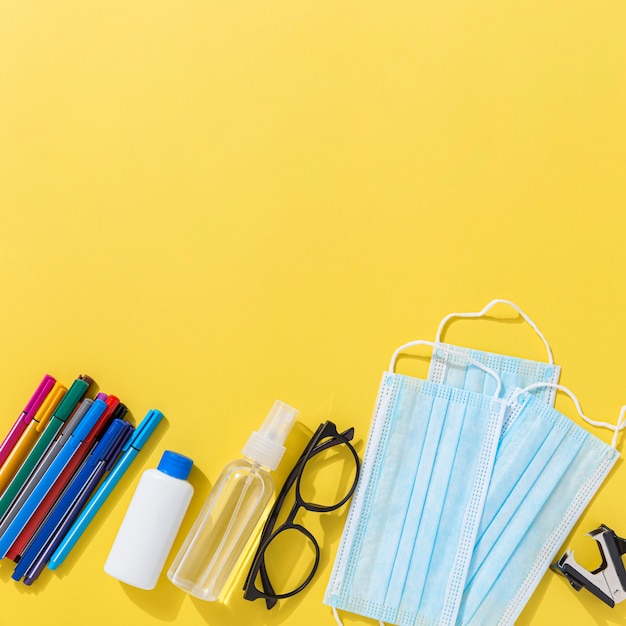 Top view of school supplies with pencils and hand sanitizer