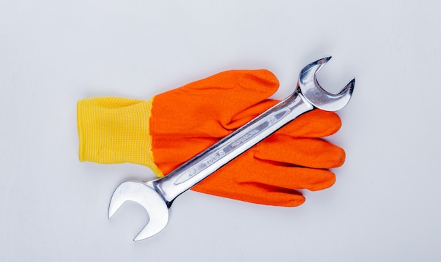 Top view of screwdriver on glove on white background