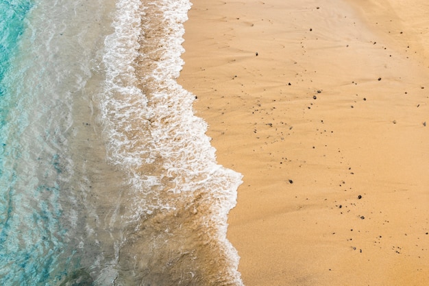 Top view sea water touching sand at the shore