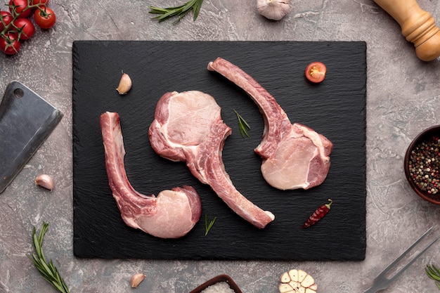 Top view seasoned meat on wooden board