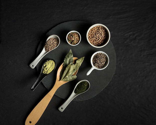 Free photo top view seasoning spices on wooden spoons