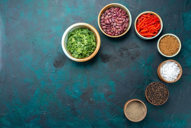 Free photo top view seasonings and beans with greens on the dark-blue background pepper green product color photo