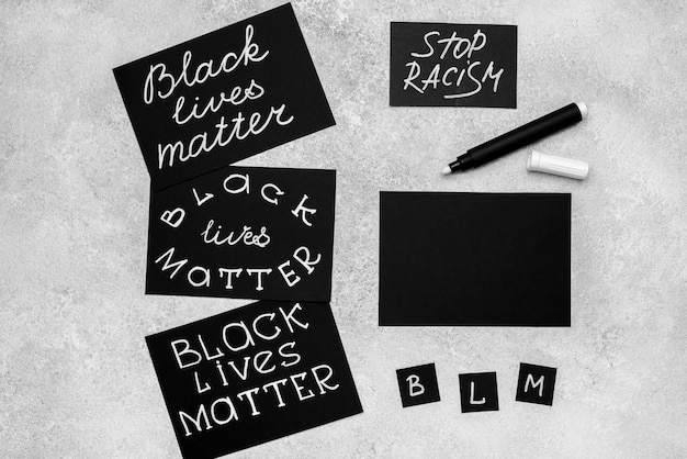 Free Photo top view of selection of cards with black lives matter and pen