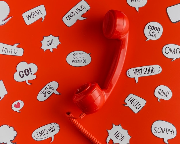 Free photo top view of selection of chat bubbles with telephone receiver