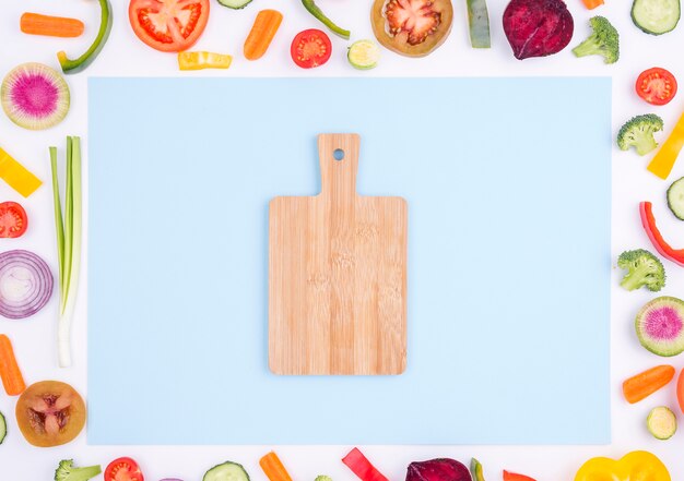 Top view selection of organic vegetables with chopping board