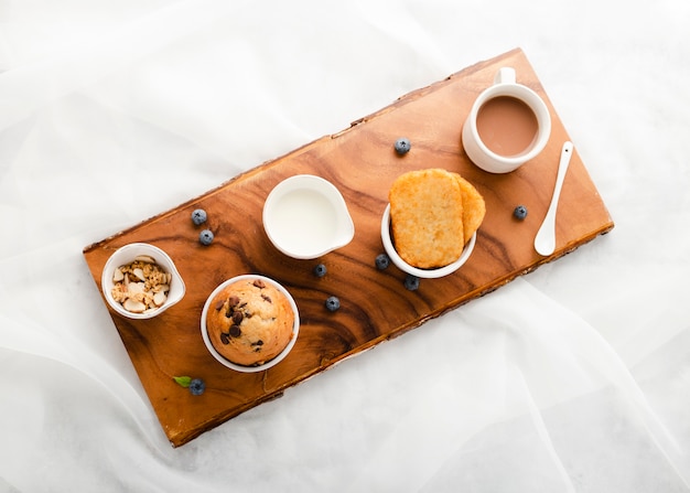 Top view set of muffin next to coffee mug