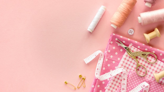 Top view of sewing essentials with thread and buttons