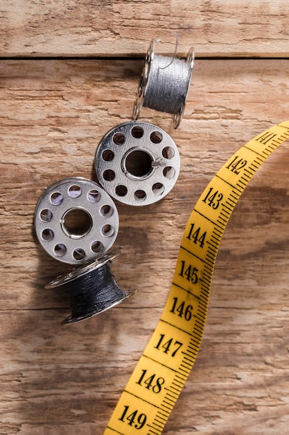 Top view of sewing machine shuttles with measuring tape