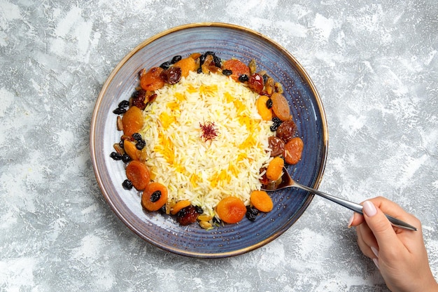 Free Photo top view shakh plov cooked rice dish with raisins inside plate on a white space