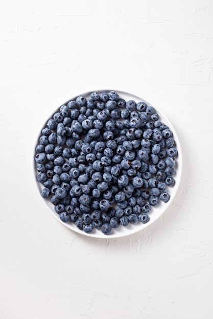 Top view shot of blueberries on a white plate