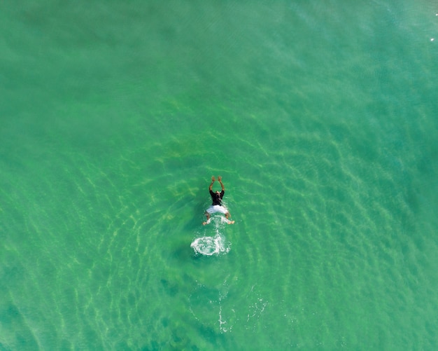 Free Photo top view shot of a person swimming in varkala beach