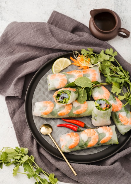 Free photo top view of shrimp rolls on plate with sauce