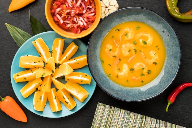 Top view shrimp soup and orange slices