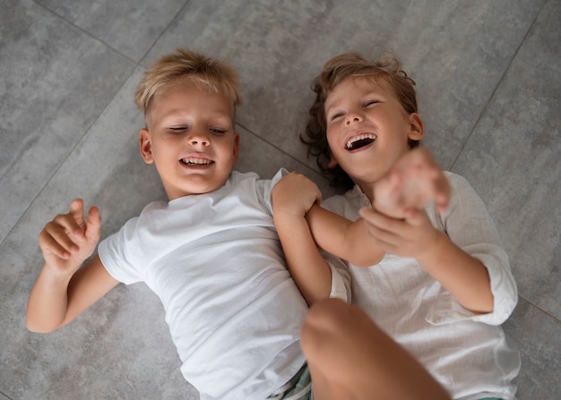 Free photo top view siblings playing together