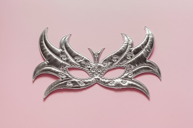 Free Photo top view silver mask on pink background