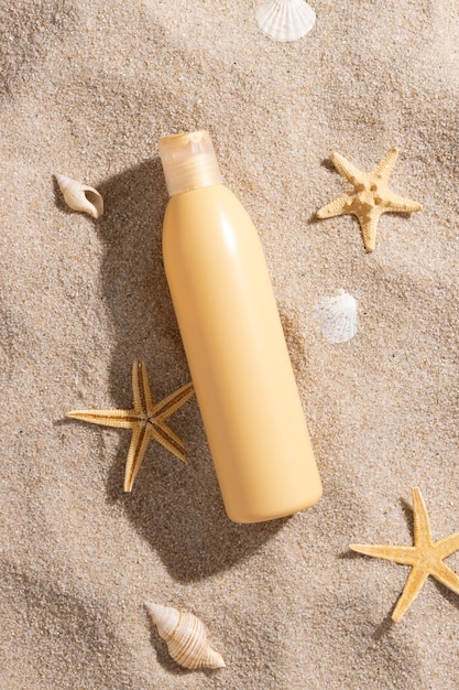 Free photo top view skincare product on the beach