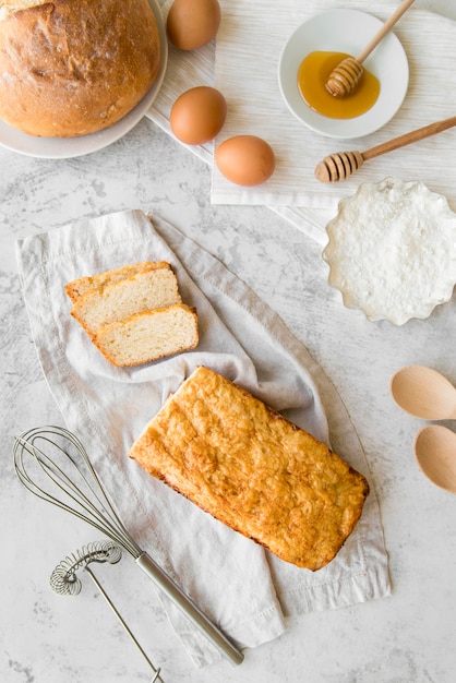 Top view sliced banana bread with eggs and honey