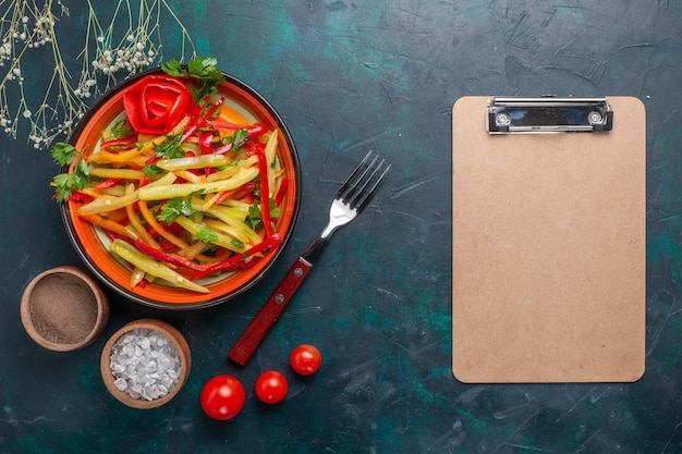 Top view sliced bell-peppers tasty healthy salad with seasonings and notepad on dark background