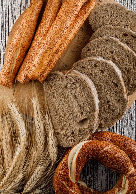 Top view sliced bread with turkish bagel, barley on wooden surface. vertical