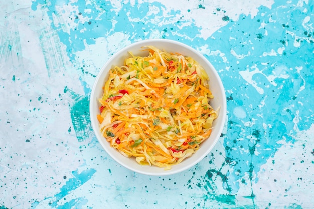 Free Photo top view sliced fresh vegetables long and thin pieced salad inside round plate on the blue background food meal vegetable salad