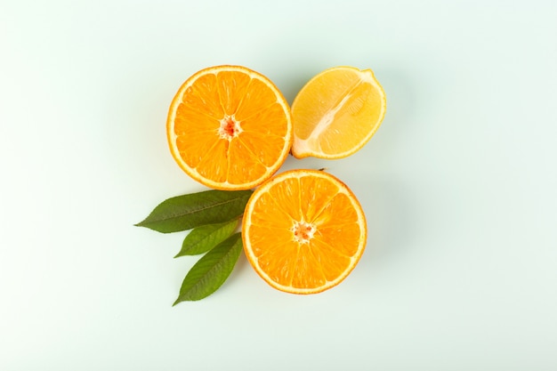 A top view sliced orange fresh ripe juicy mellow isolated half cut pieces with green leaves on the white background fruit color citrus