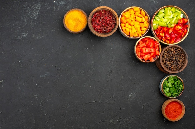 Top view sliced pepper with different seasonings on the grey background meal salad health vegetable spicy