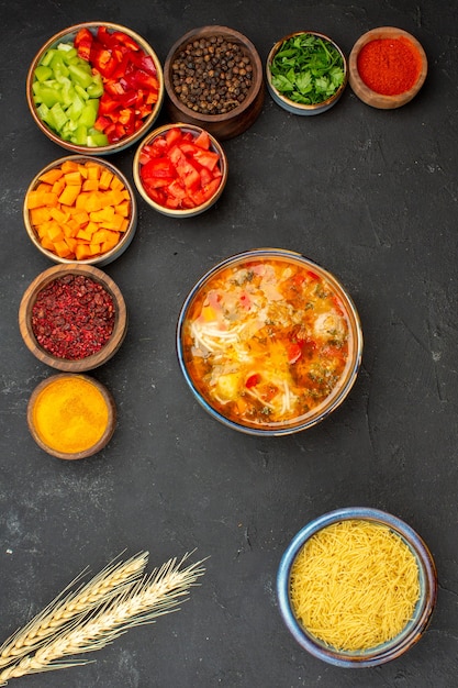 Free photo top view sliced pepper with different seasonings and soup on a grey background salad health vegetable spicy meal