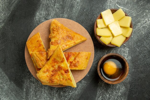 Top view sliced pie with cheese on grey background food meal pastry bake oven sweet biscuit