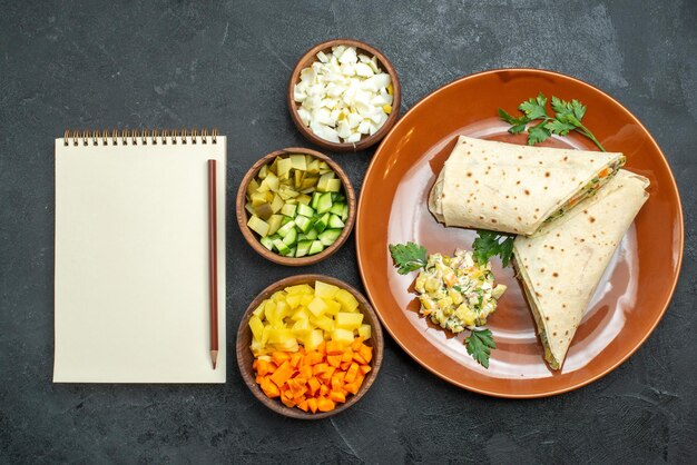 Top view sliced shaurma tasty meat and salad sandwich on grey desk burger sandwich salad bread pita meat